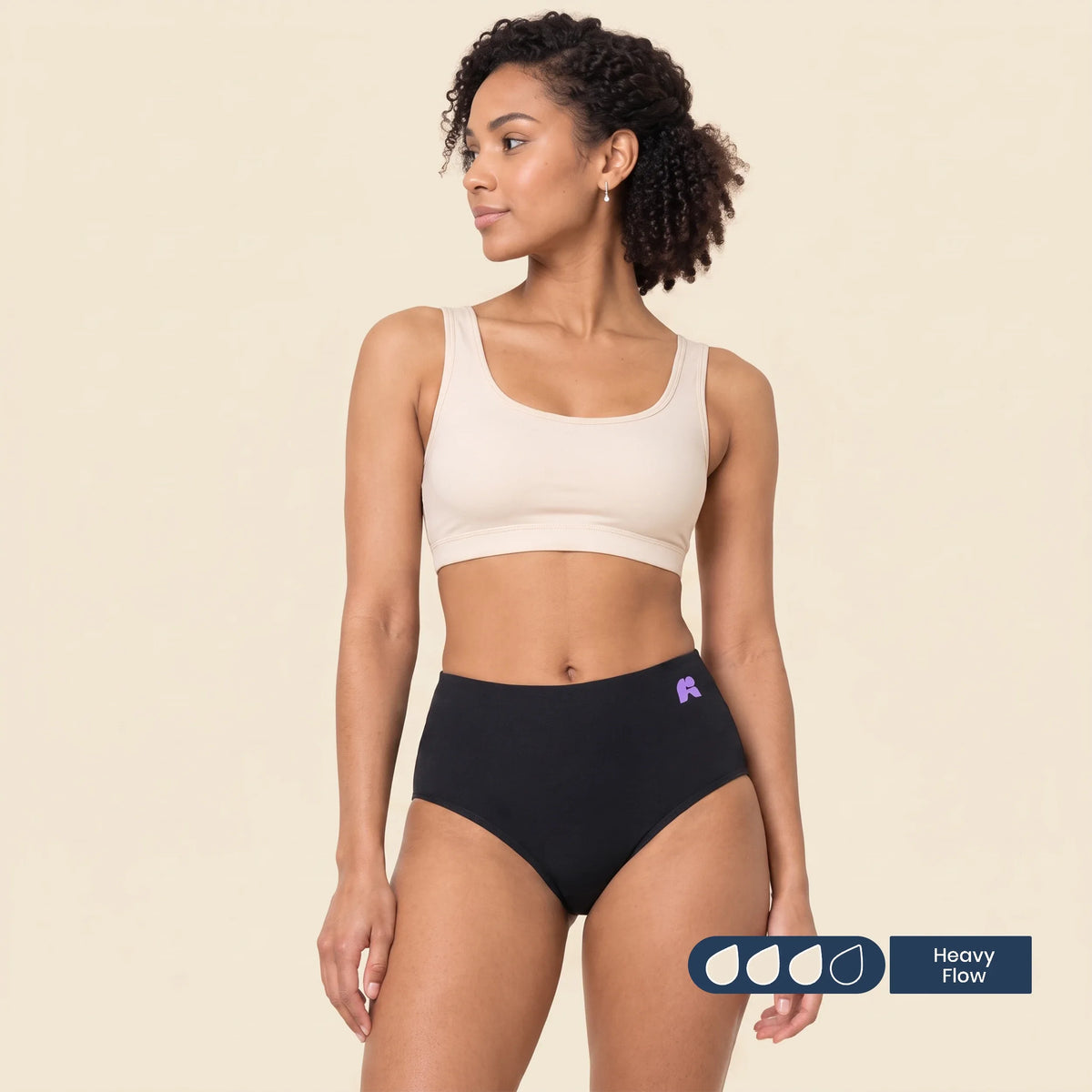Woman wearing FreeFlowa black high-rise period pants for heavy flow